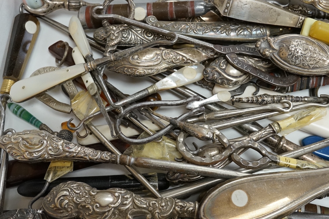 A large collection of Victorian button hooks, with silver, plate, mother of pearl and other handles